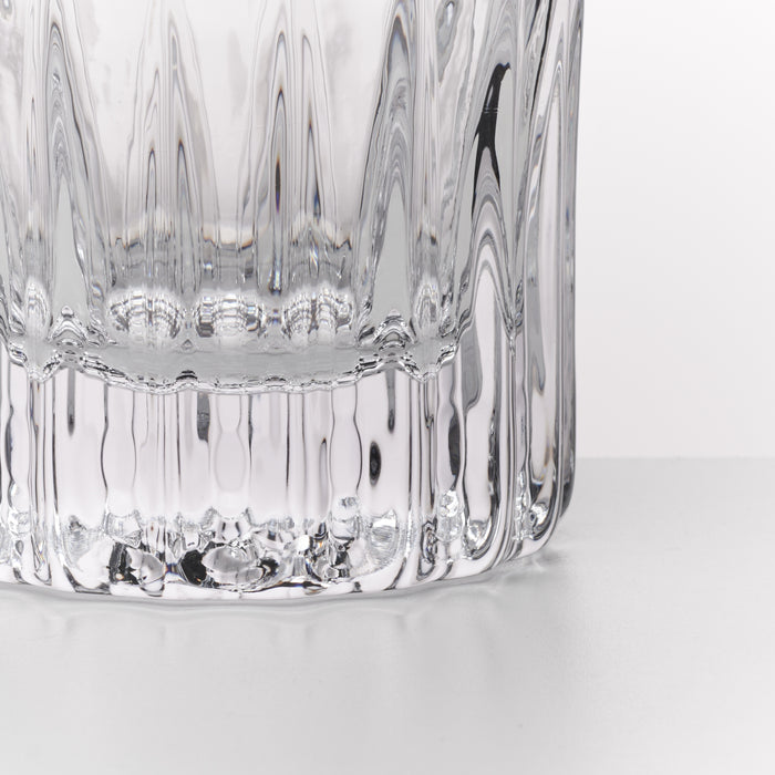 Two clear crystal lowball glasses with vertical ribbed pattern and textured base.