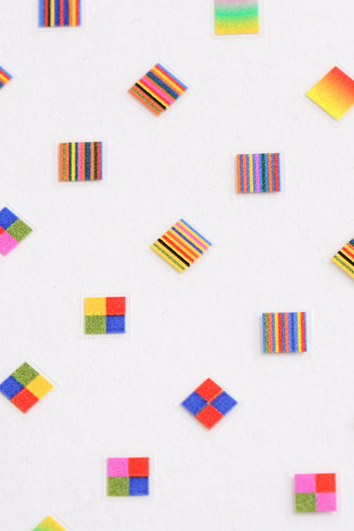 Nail stickers with colorful stripes and checkerboard patterns by Amber Vittoria.