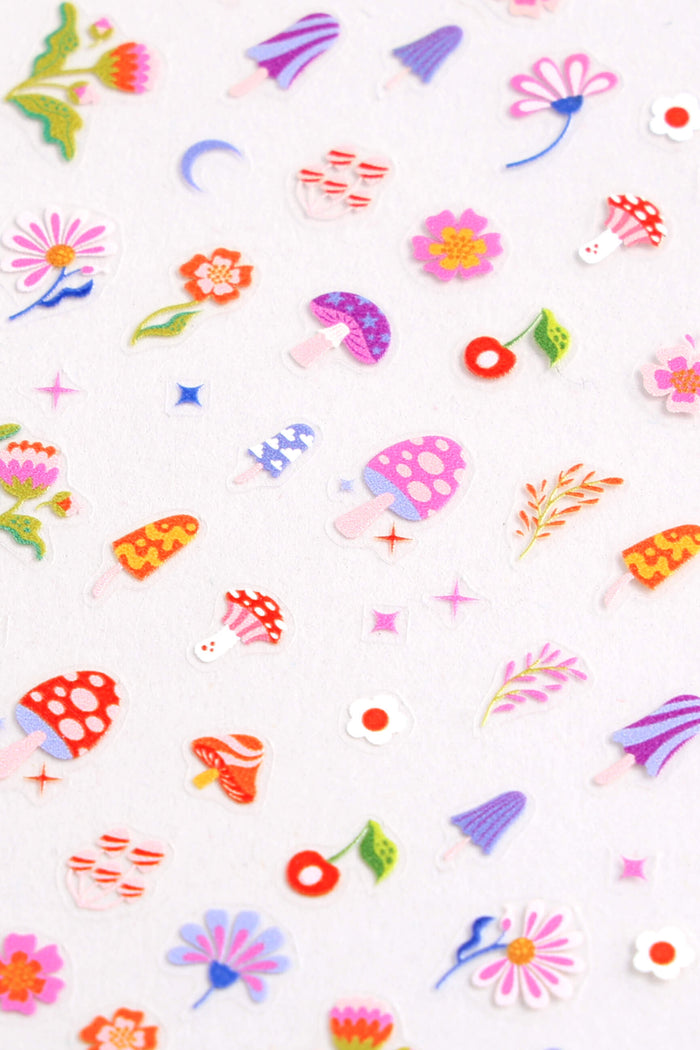 Sheet of cute nail stickers featuring mushrooms, flowers, cherries, and popsicles in vibrant colors.