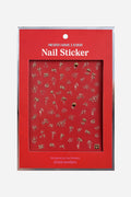 Gold floral nail stickers by Zoe Wodarz on a red backing card.