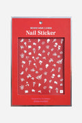 White floral nail stickers by Zoe Wodarz. Delicate flower & leaf designs on red backing.