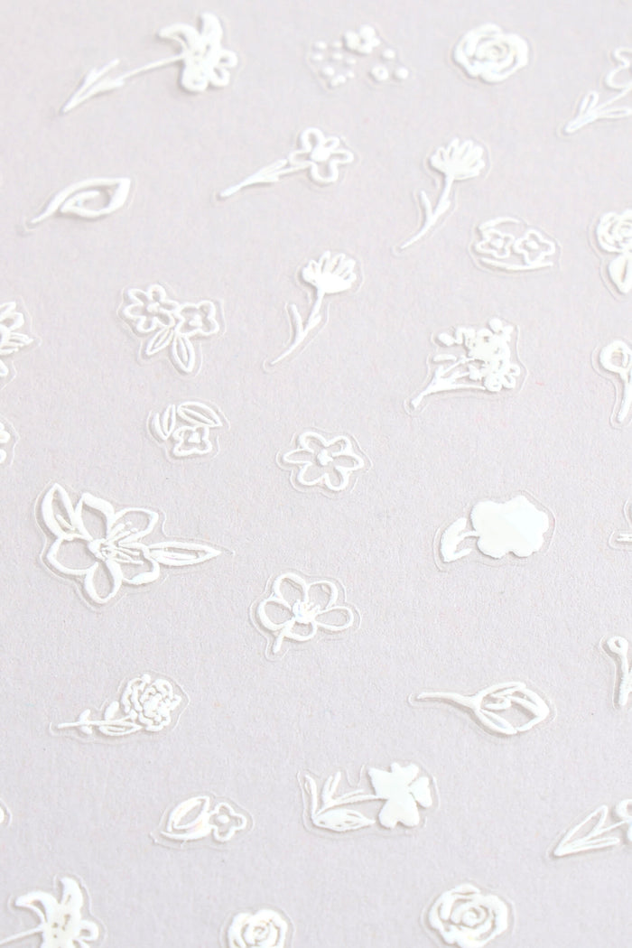 White floral nail stickers with delicate hand-drawn designs.