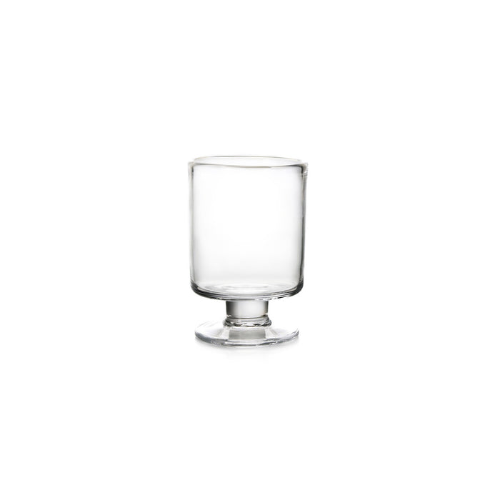 Clear glass hurricane-style votive holder with pedestal base and cylindrical body.