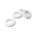 Four white marble napkin rings with smooth, rounded oval shapes arranged in a group.