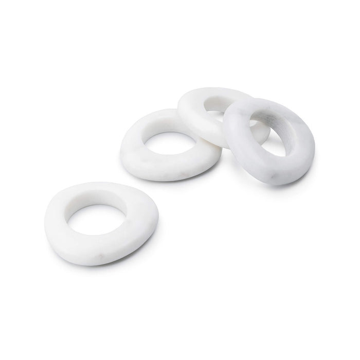 Four white marble napkin rings with smooth, rounded oval shapes arranged in a group.