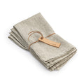 Four natural linen napkins with hemmed edges, bundled with a leather tie.