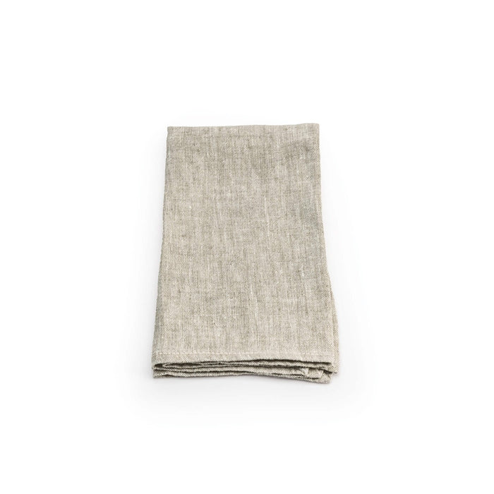 Folded natural linen napkin with visible hemstitched edge detail.