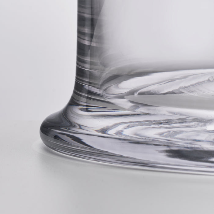 Clear glass ice bucket with black and white swirled pattern detail on cylindrical body and rim.