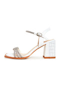 A stylish pair of white Alisa sandals with open toes and block heels, perfect for any summertime outfit.