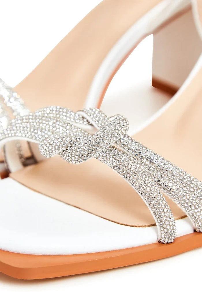 A stylish pair of Alisa white open toe block heel sandals, perfect for adding a touch of sophistication to any outfit.