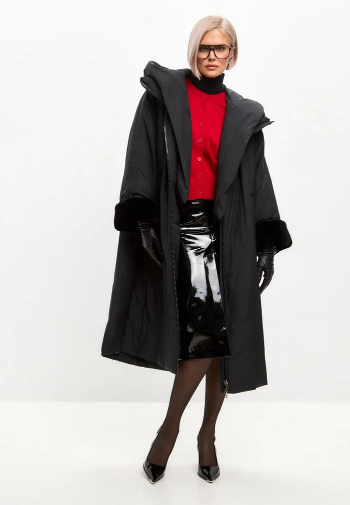 A stylish black oversized puffer coat with a hood and faux fur cuffs - the perfect plus size outerwear for keeping warm and in style this winter in women's fashion.