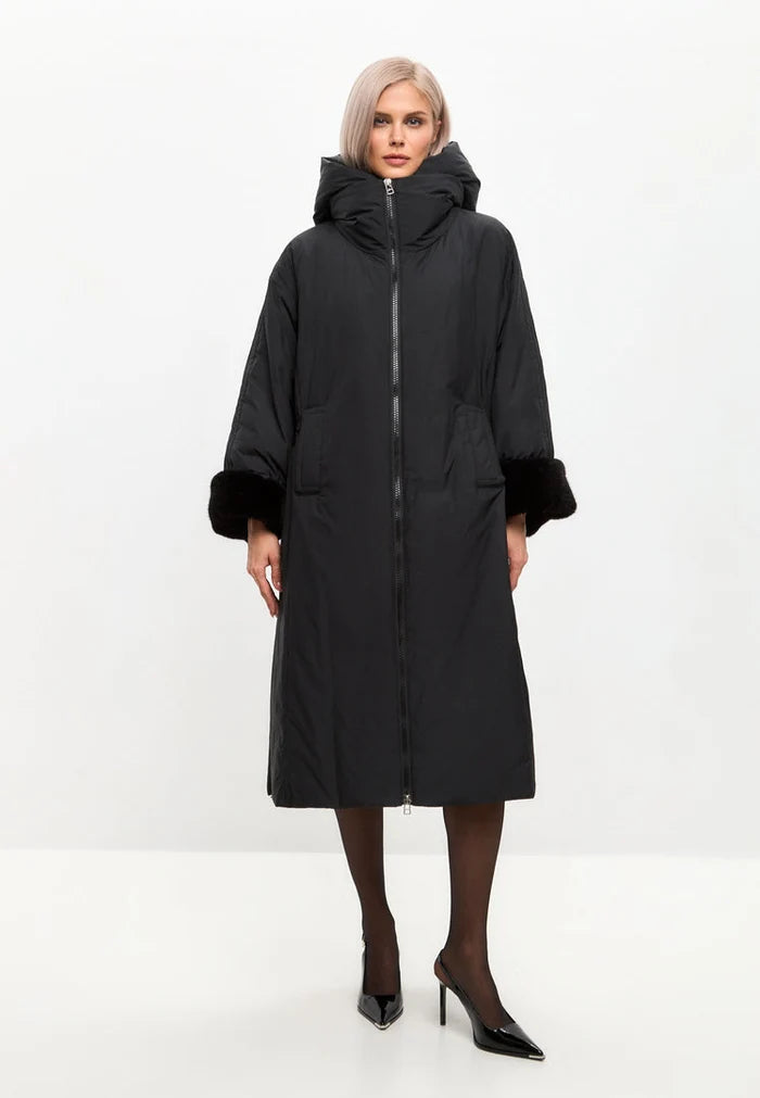 A stylish black oversized puffer coat with a hood, faux fur cuffs, and designed as plus size outerwear in the latest women's fashion trends.