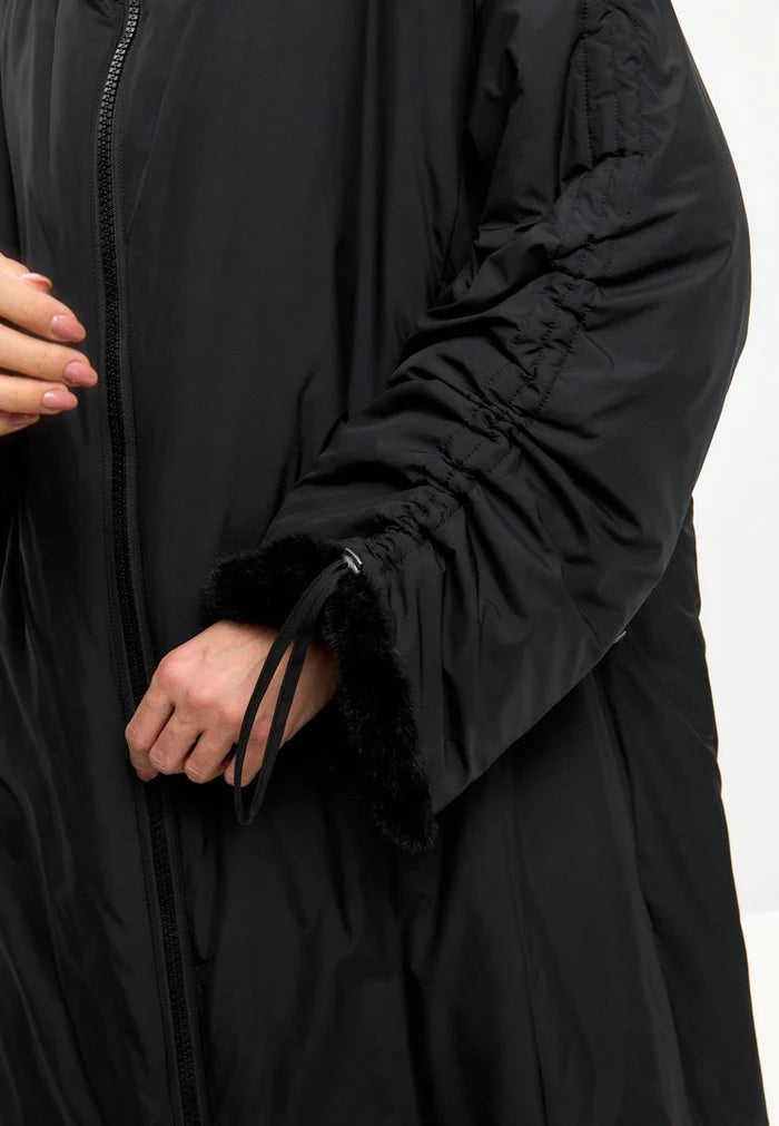 A stylish black oversized puffer coat with a hood and faux fur cuffs, perfect for plus size outerwear in women's fashion.