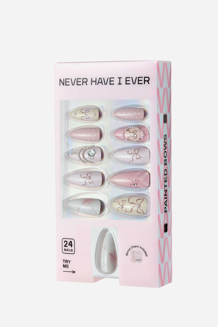 Never Have I Ever Painted Bows almond press-on nails with pink polka dots and pearl accents