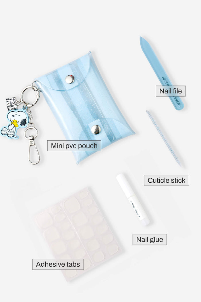 Peanuts Faux Nail Fix-It Kit with Snoopy charm, mini blue pouch, nail file, cuticle stick, adhesive tabs, and nail glue.