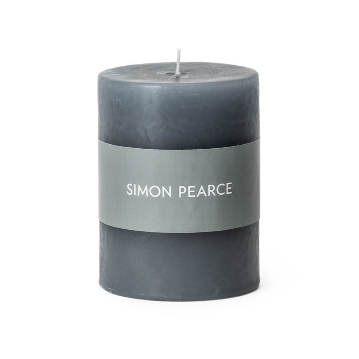 Pewter-colored pillar candle with gray band label and white center wick.