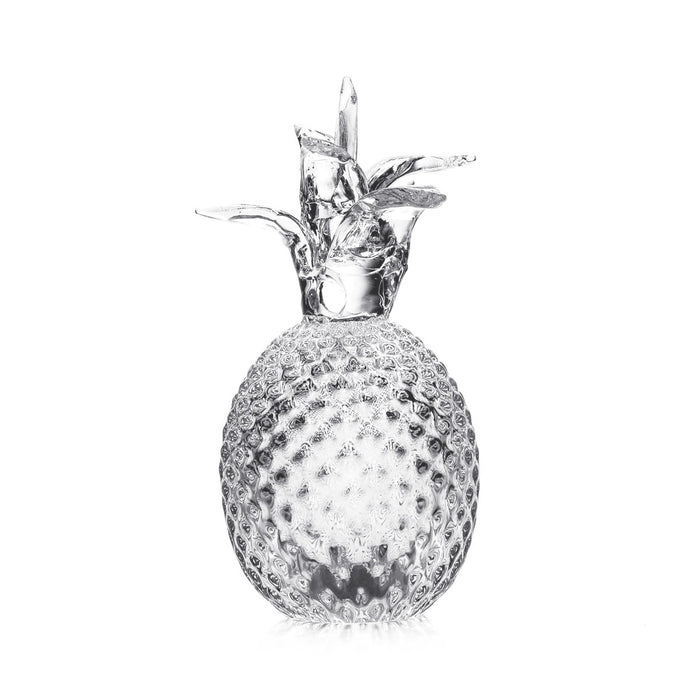Fresh pineapple with textured skin and leafy crown on white background.