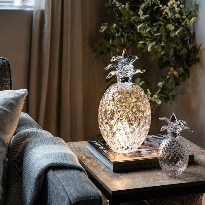 Silver pineapple-shaped decorative lamp with textured surface and crown-like leaves on top.