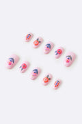Pink press-on nails with floral designs, featuring orange and blue accents.