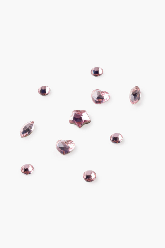 Pink tooth gems in various shapes including hearts and stars