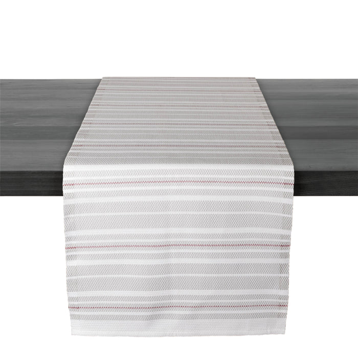 White and gray striped table runner with red accent lines draped across dark surface.