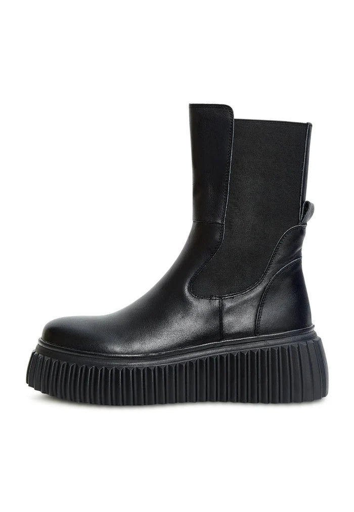 A trendy pair of black Chelsea boots with a ribbed sole and platform design, perfect for women's footwear fashion.