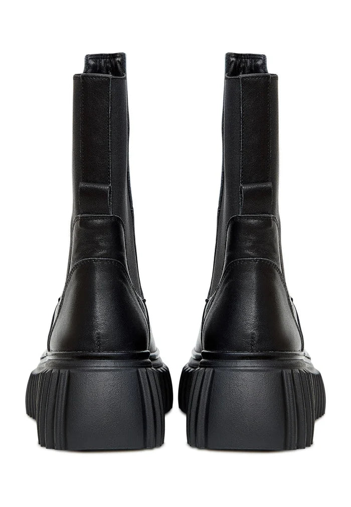 A stylish pair of women's black Chelsea boots with a trendy ribbed sole, perfect for a comfortable and fashionable look.
