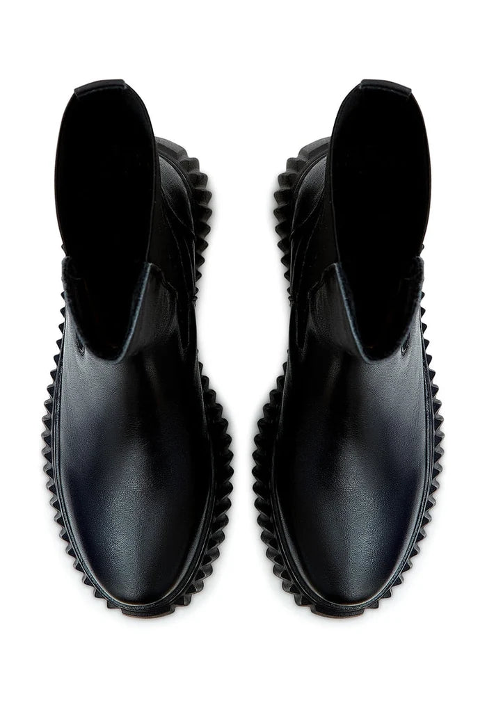 A fashionable pair of black Chelsea platform boots with ribbed soles, perfect for women's footwear collections.