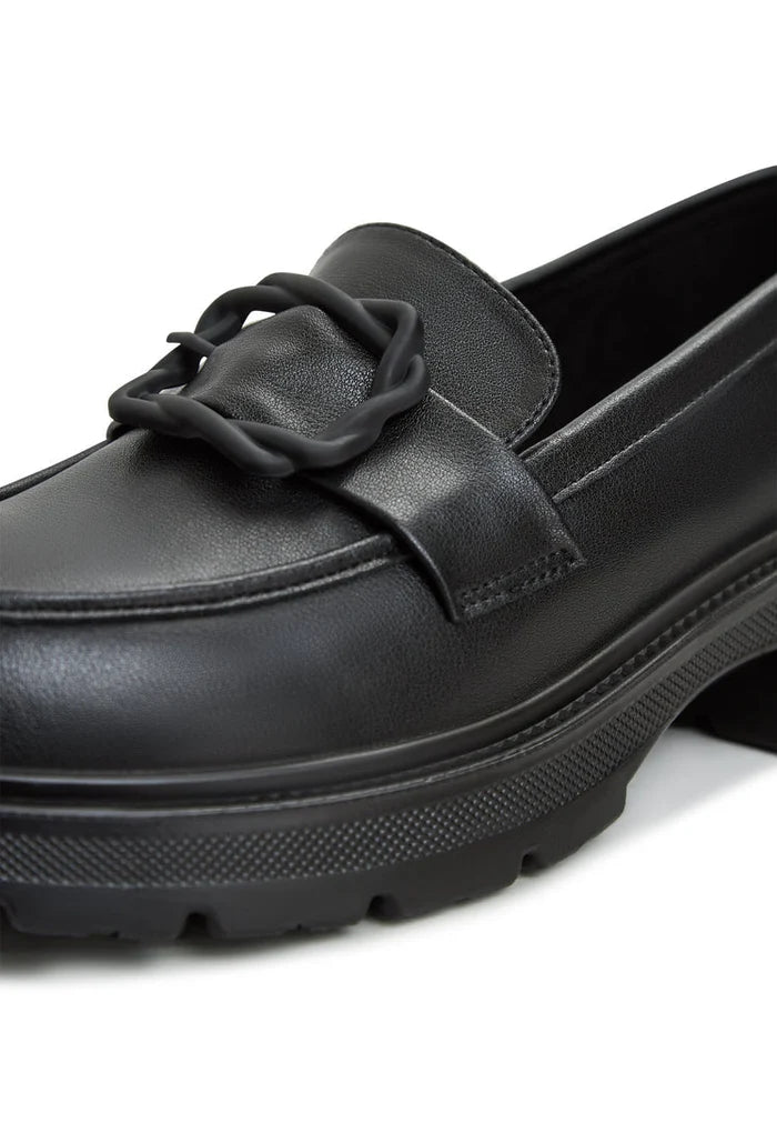 A fashionable pair of black platform loafers, perfect to match with a sari or any women's outfit for a stylish look.