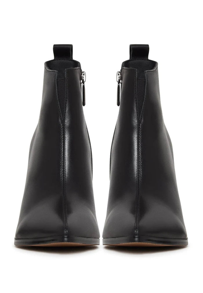 A pair of black pointed toe ankle boots with block heels, made of stylish leather.