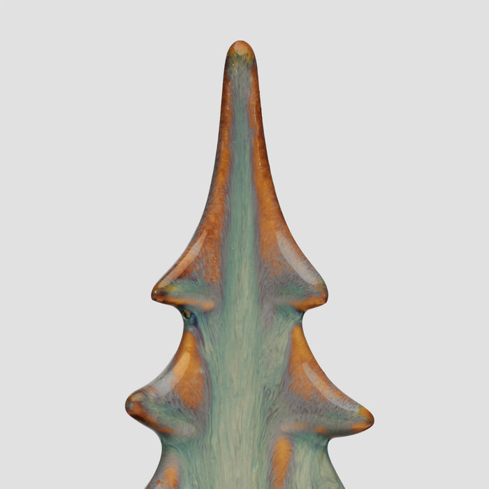 Tall ceramic evergreen tree with moss green glaze and russet-brown accents on protruding branches.