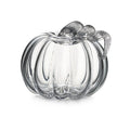 Clear glass pumpkin-shaped container with ribbed sides and a twisted vine handle at the top.