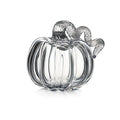 Clear glass pumpkin-shaped container with ridged body and twisted handle on top.