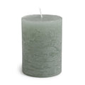 Sea foam green pillar candle with white wick and textured finish.