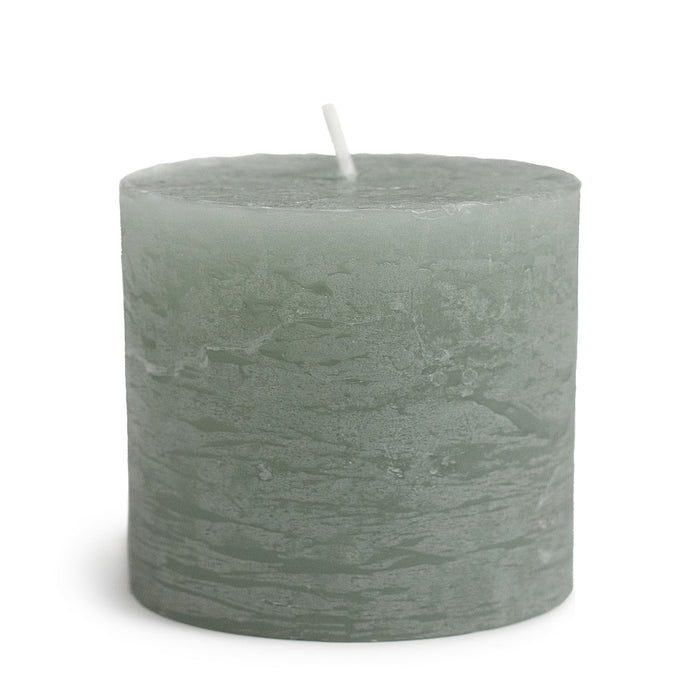 Sea foam green pillar candle with white wick and textured surface.