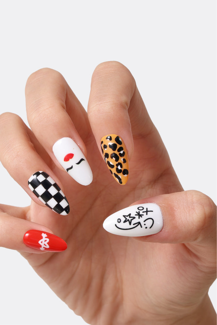 Retro Rock ‘n’ Roll press-on nails with checkerboard, cartoon face, leopard print, and tic-tac-toe designs.