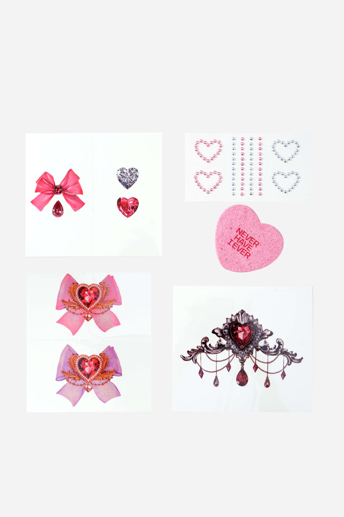 Temporary tattoos featuring rococo-inspired heart designs, bows, and rhinestones.