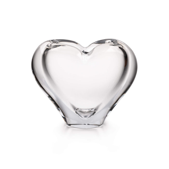 Clear glass vase in a heart shape with curved sides and flat bottom.
