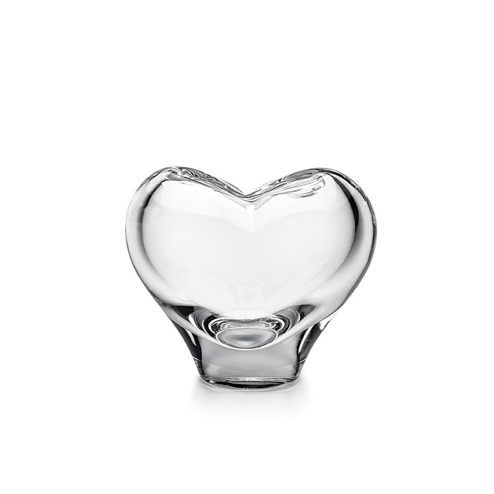 Clear glass vase with heart-shaped design and curved opening at top.