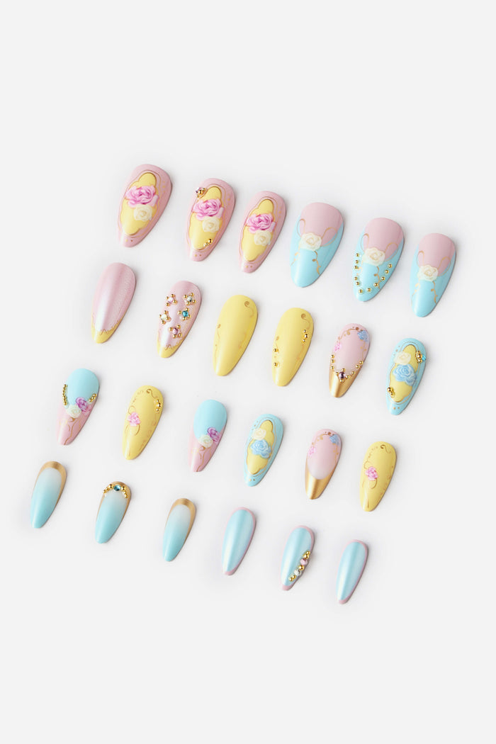 Assortment of almond-shaped press-on nails in pastel colors with floral and gem embellishments.