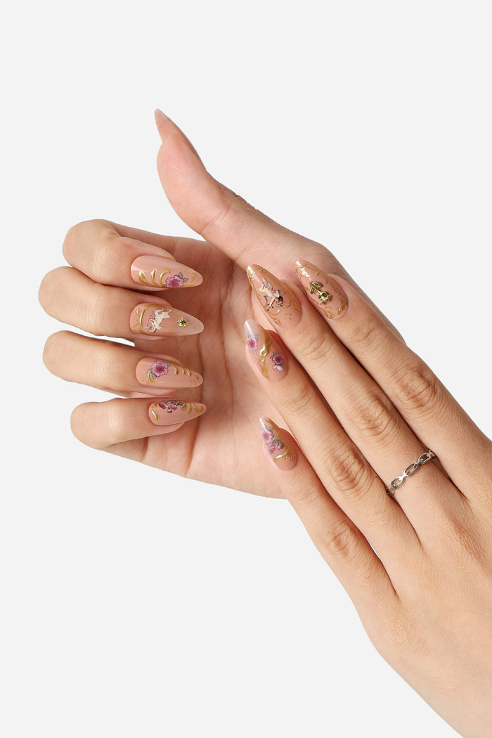 Almond press-on nails with rose gold rococo design, featuring floral accents and gold filigree.