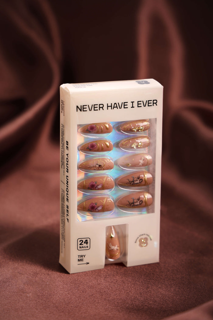 Rose gold rococo almond press-on nails with floral and cherub designs.