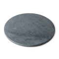 Round grey soapstone board with flat surface and slightly beveled edge.