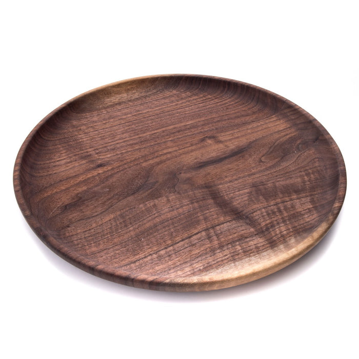 Round wooden tray with dark brown finish and visible grain pattern, shallow raised edge on white background.