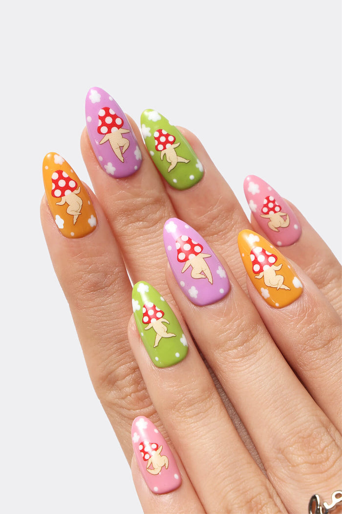Colorful press-on nails with cute mushroom character designs in purple, green, orange, and pink.