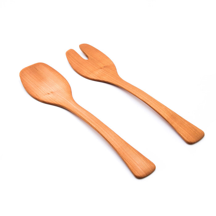 Pair of wooden salad servers with cherry wood finish, one spoon and one fork design.