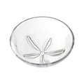 White ceramic bowl with sand dollar pattern embossed on interior bottom.