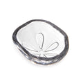 White ceramic bowl with dark grey rim and sand dollar relief pattern in center.