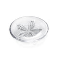 Clear glass plate with embossed sand dollar design in center.