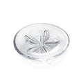 Clear glass plate with embossed sand dollar design in center.